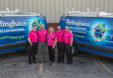 Arlinghaus employees smiling in front of fleet vehicles