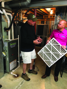 Arlinghaus technician speaks to homeowner about changing HVAC filters