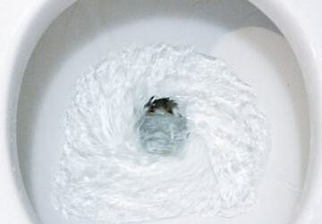 A toilet bowl with swirling water.