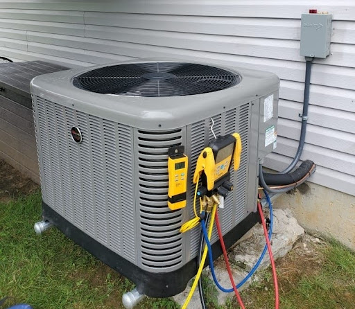 Air conditioning unit outside of Erlanger home in the process of being serviced, with tools surrounding it.
