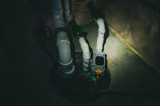 A sump pump with a light shining on it.