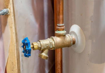 A close-up of a water heater drain valve.