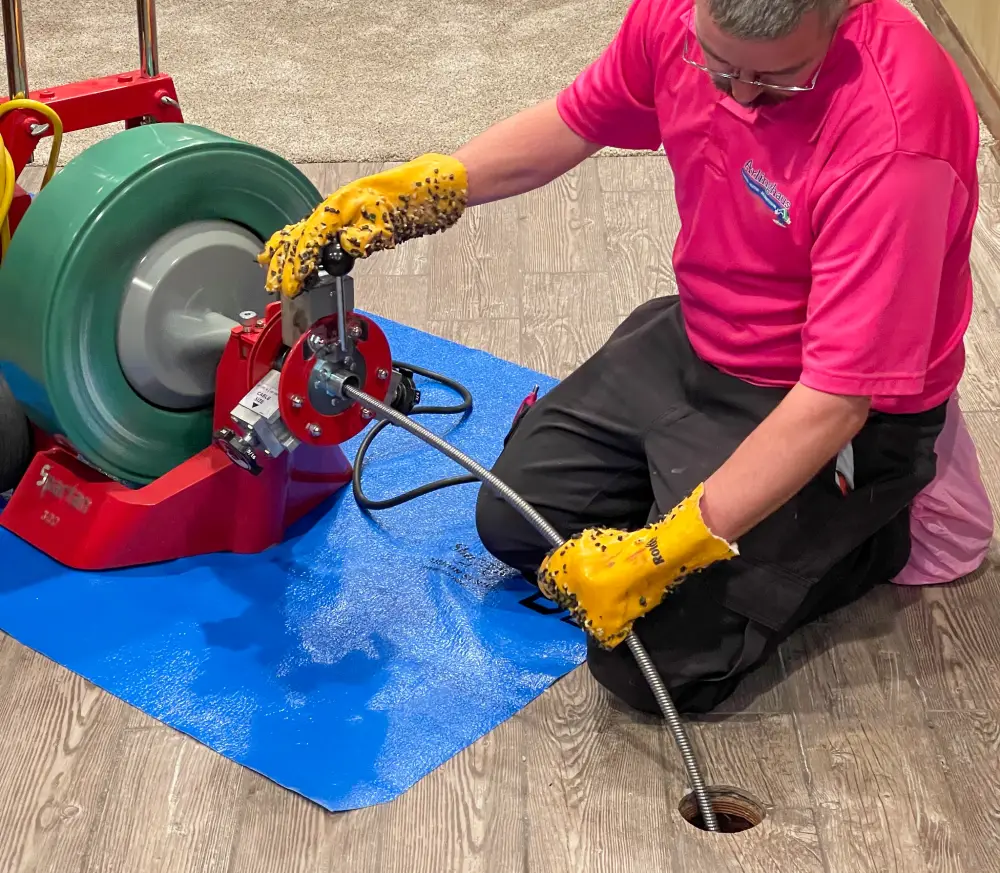 Technician working with an equipment with a pipe inside a hole