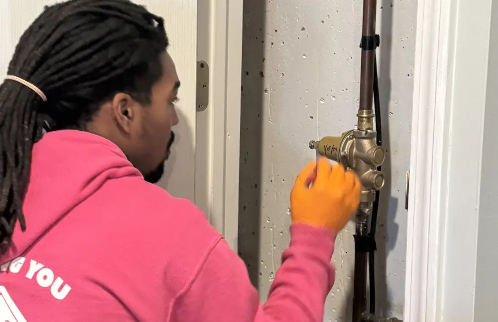 Technician checking on a pipe