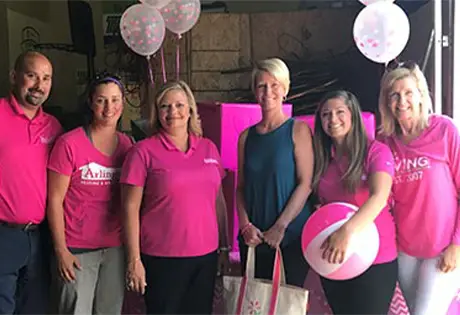 Smiling technician holding clipboard.
