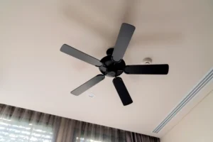 A black ceiling fan inside a room